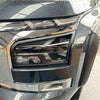 Headlight covers for mitsubishi triton 2024+ in matte black with sleek angular design and chrome accents on luxury suv