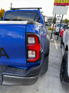 Blue toyota hilux 2021-2025 sr5 pickup truck back side with black roof rack and red taillight covers installed