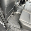 Black rubber heavy duty floor mats with textured ridges and circular cutouts for 2024 mitsubishi triton interior