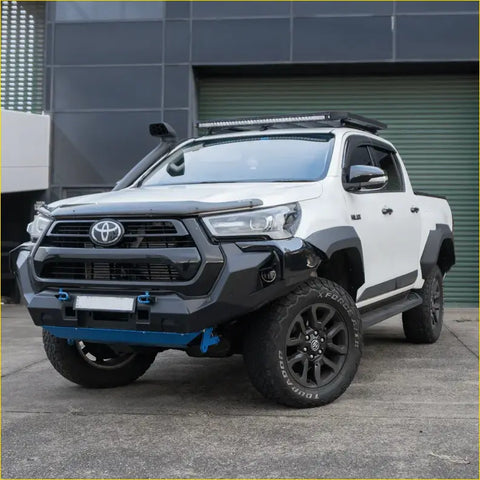 White toyota hilux ute with black front bumper roof rack offroad tires and hilux n80 gr style flares for 4wd use