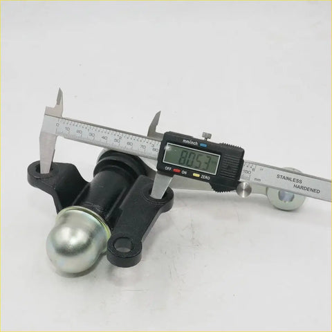 Black metal idler arm support with shiny silver hitch ball measured by digital caliper for toyota hilux 1988-1997