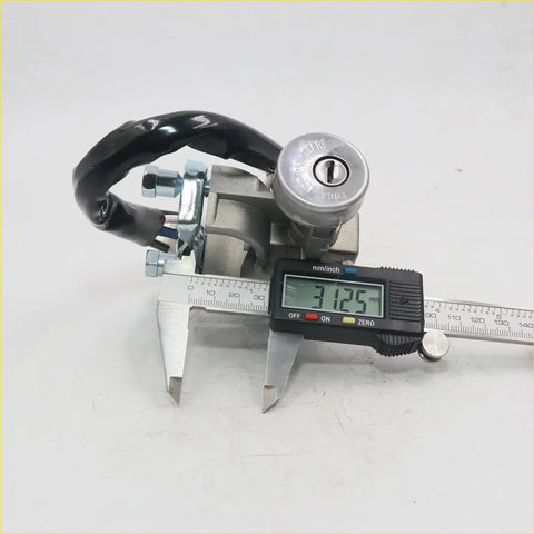Black and silver ignition switch with keyhole mounted on metal bracket for mazda b1600 b1800 1982-1984