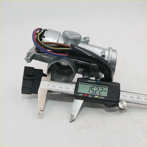 Silver metallic door lock actuator with wiring and digital caliper measuring width for toyota hilux 1983-1988