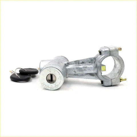 Silver metal motorcycle ignition lock for datsun nissan bluebird with two black keys beside it