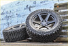 Black kenda klever rt all-terrain tires mounted on dark gray multi-spoke alloy wheels for rugged use