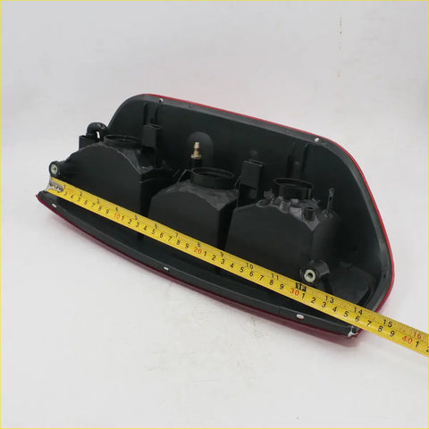 Lh rear tail light x2 for Nissan Navara D40 2005-2012 showing black and red plastic molded housing back view