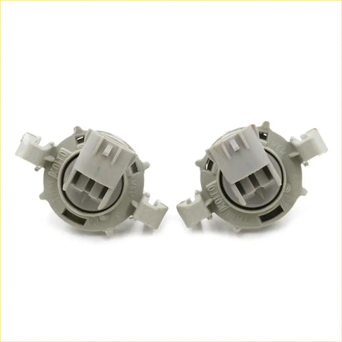 Gray plastic car headlight bulb sockets with molded tabs and central connector housings for toyota hilux license plate lightset back view