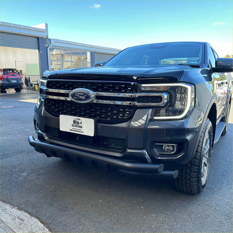 Black ford ranger 2022+ with low bar nudge bar chrome grille and rugged off-road tires for tough terrain