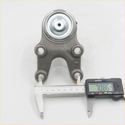 Gray metallic lower ball joint with circular rubber top and four mounting holes for Nissan Caravan Homy E23