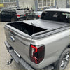 Gray metallic manual roller shutter tonneau cover on the back of a ford ranger sport pickup truck 2022+ new ranger