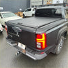 Black hard manual roller shutter tonneau cover with matte finish and rear handle on mitsubishi triton 2024+ back side