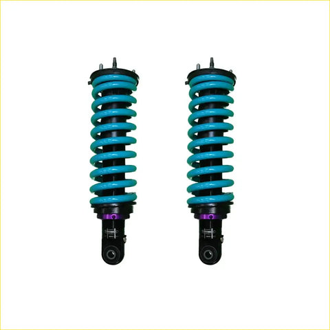 A pair of turquoise coil-over shocks with black and purple accents for mazda bt-50 series iii dobinsons ims monotube off-road use