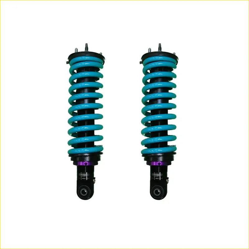 A pair of turquoise coil-over shocks with black and purple accents for mazda bt-50 series iii dobinsons ims monotube off-road use