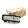 Black-framed toyota hilux mirror cover turn signal light with clear lens and orange side marker indicator
