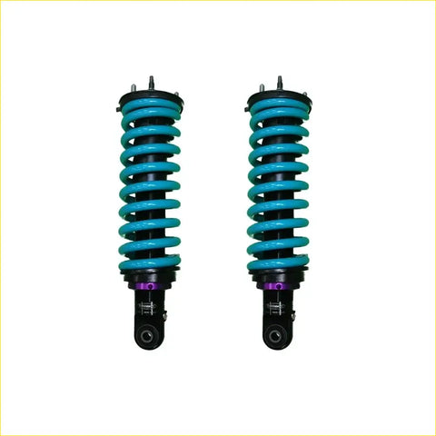 A pair of dobinsons ims monotube front lift shock absorbers for mitsubishi triton mv 2024 with teal springs and purple accents