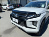White mitsubishi triton pickup with black accents and bold front grille featuring monsoon and bonnet guard style