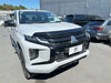 White Mitsubishi Triton pickup with black grille and bumper featuring monsoon and bonnet guard aftermarket style