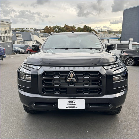 Black Mitsubishi Triton 2024 with Monsoon bonnet guard featuring bold angular grille and chrome accents