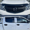 White mazda bt-50 pickup truck with black grille chrome emblem and tinted window visors featuring monsoon and bonnet guard