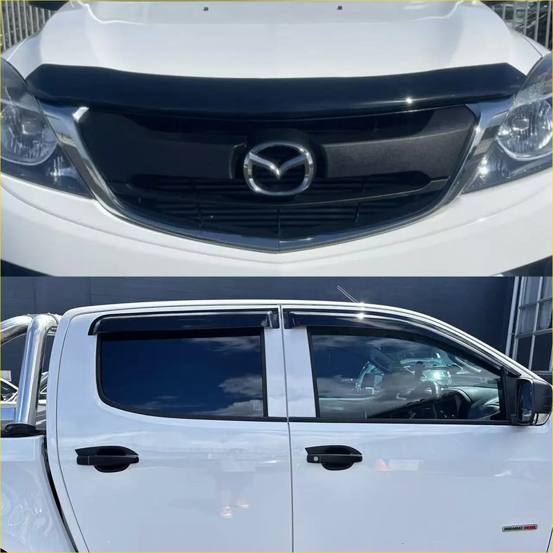White mazda bt-50 pickup truck with black grille chrome emblem and tinted window visors featuring monsoon and bonnet guard