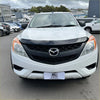 White mazda bt-50 pickup with black front grille and chrome emblem featuring monsoon and bonnet guard 2012-2020