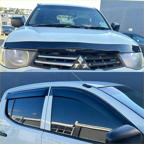 White mitsubishi triton pickup with black front grille chrome accents and dark tinted window visors with monsoon bonnet guard