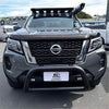 Gray nissan navara 2021-2025 with monsoon bonnet guard black roof rack and front bumper guard shown from front side