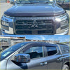 Dark gray metallic mitsubishi triton 2024 with monsoon and bonnet guard featuring black honeycomb grille and chrome accents