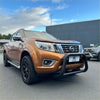 Bronze nissan navara np300 pickup truck with black alloy wheels and monsoon bonnet guard oem style 2015-2020 front view