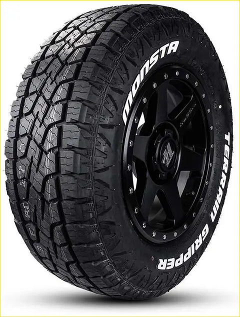 Black rubber monsta terrain gripper a t tire with deep tread mounted on black alloy wheel size 285 50 r20