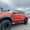 Red ford ranger wildtrak with matte black bolt style monster flare and rugged off-road tires for 2012-2015 model