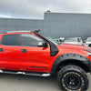 Red ford ranger wildtrak with matte black bolt style monster flare fender flares and roof rack in front view