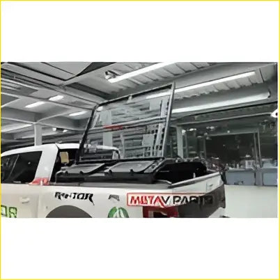 The back side of a ford ranger t9 2022-on truck showing a black metal multifunctional heavy duty roof rack with cargo net