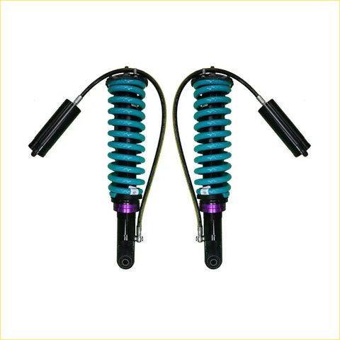 A pair of teal-coiled dobinsons monotube remote suspension shocks for nissan navara frontier d40 with black purple accents