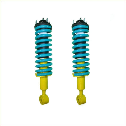 A pair of turquoise and yellow coil-over suspension shocks with black mounts for nissan pathfinder r51 diesel 25l tdi