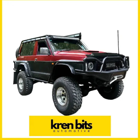Red and black two-tone lifted nissan safari GQ Y60 monsoon SWB with rugged tires roof rack and bold front bumper