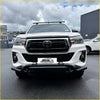 White toyota hilux pickup with black nudge bar lower style compatible with front camera and sensors