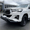 White toyota hilux with a black lower style nudge bar featuring chrome accents compatible with front camera and sensors