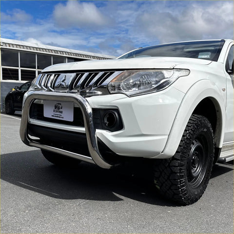 White mitsubishi triton pickup with a chrome nudge bar compatible with front sensors 2005-2015 model