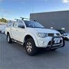 White mitsubishi triton pickup with matte black nudge bar compatible with front sensors and roof rack