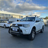 White Mitsubishi Triton pickup with matte black nudge bar compatible with front sensors 2005-2015 model