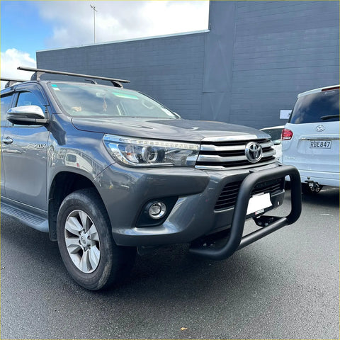 Gray metallic toyota hilux with matte nudge bar compatible with front sensors black bumper guard and roof rack