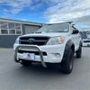 White toyota hilux pickup truck with chrome nudge bar compatible with front sensors and black side cladding
