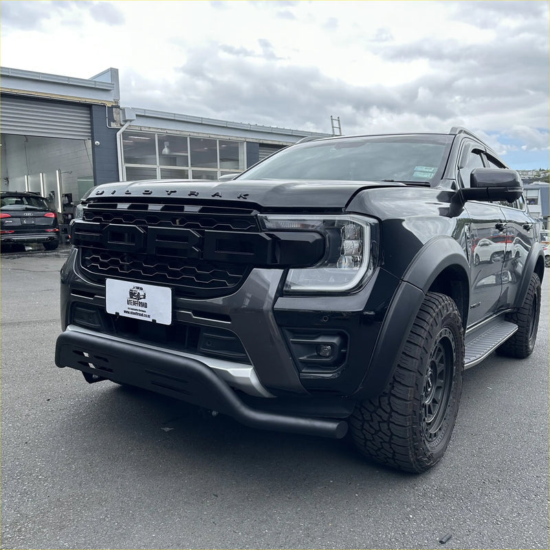 Black ford ranger wildtrak with a rugged matte finish and aggressive front grille featuring a nudge bar for 2022+ models