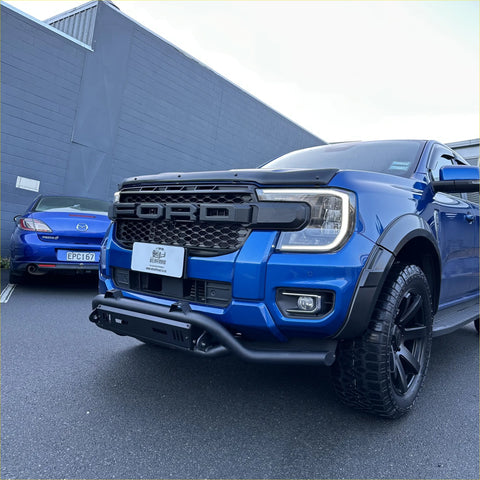Vibrant blue ford ranger with black nudge bar lower style bumper guard and aggressive grille design 2022 plus
