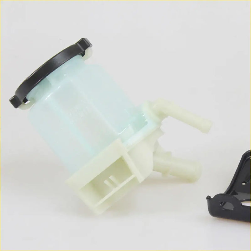 Translucent light blue plastic power steering fluid reservoir with black cap and beige fittings for toyota hilux diesel