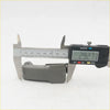 Gray plastic camera grip being measured with digital caliper for quarter glass lock latch mazda b2000 1985-2006