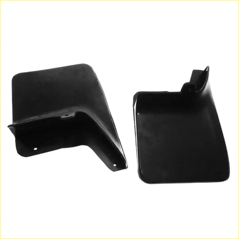 Black plastic rear mud guard flap with molded contours and mounting holes for nissan navara d22 1997-2004 shown back side