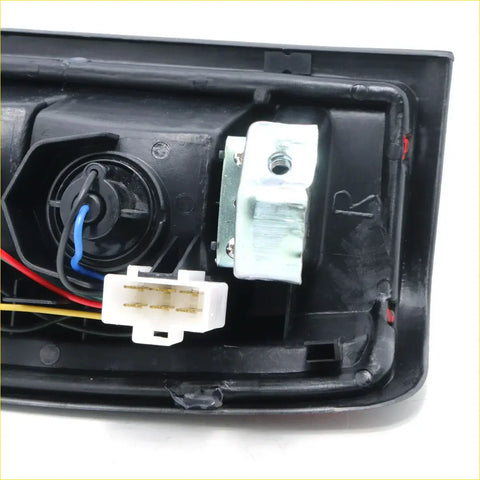 Back side of black plastic rear tail light housing with wiring and connector for nissan navara d22 1998-2004