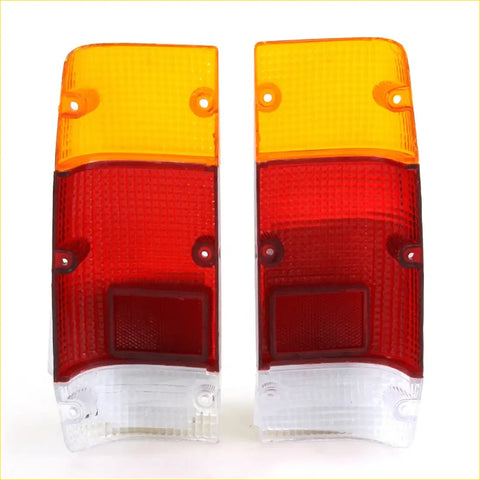 Pair of vintage-style red and amber rear tail light lens assemblies with clear plastic bases for Nissan Datsun 720 1980-1986